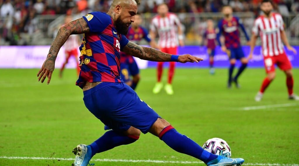 Barcelona's Chilean midfielder Arturo Vidal crosses the ball during the Spanish Super Cup semi final between Barcelona and Atletico Madrid on January 9, 2020, at the King Abdullah Sport City in the Saudi Arabian port city of Jeddah. - The winner will face Real Madrid in the final on January 12. (Photo by Giuseppe CACACE / AFP)