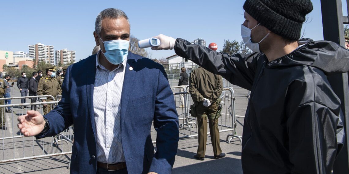 Chile's National Football Associaton (ANFP) President Pablo Milad, gets his temperature measured at the entrance of the Monumental stadium before the start of the first division football match between Colo Colo and Santiago Wanderers in Santiago, on August 29, 2020 amid the COVID-19 pandemic. - The match is played without spectators as a preventive measure against the spread of the novel coronavirus. (Photo by MARTIN BERNETTI / AFP) (Photo by MARTIN BERNETTI/AFP via Getty Images)
