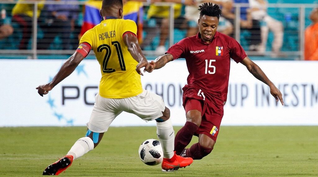 Ecuador's defender Gabriel Achilier (L) and Venezuela's forward Jhon Murillo (R) vie for the ball during the international friendly football match at the Hard Rock Stadium in Miami Gardens, Florida, on June 1, 2019. (Photo by RHONA WISE / AFP)