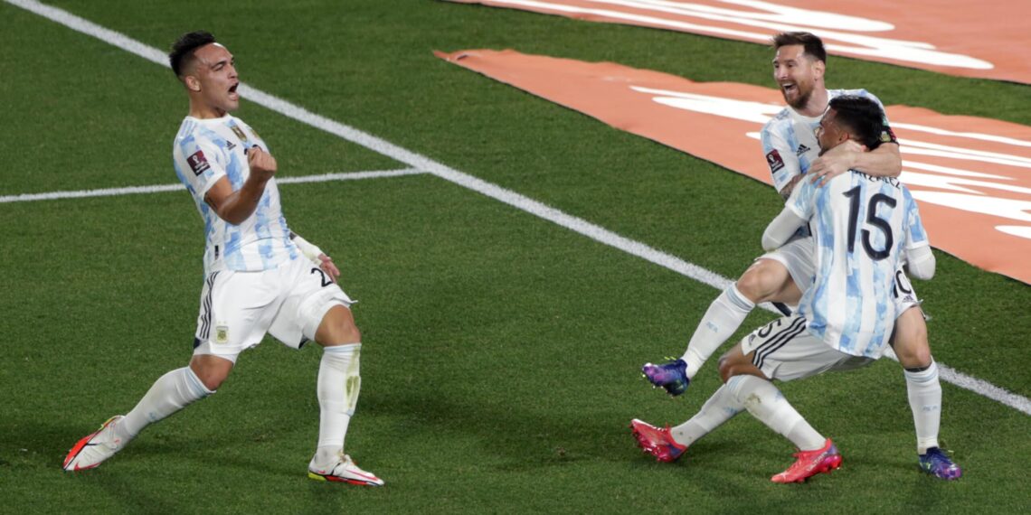 BUENOS AIRES, ARGENTINA - OCTOBER 10: Lionel Messi of Argentina celebrates with teammate Nicolás Gonzalez after scoring the first goal of his team during a match between Argentina and Uruguay as part of South American Qualifiers for Qatar 2022 at Estadio Monumental Antonio Vespucio Liberti on October 10, 2021 in Buenos Aires, Argentina. (Photo by Daniel Jayo/Getty Images)