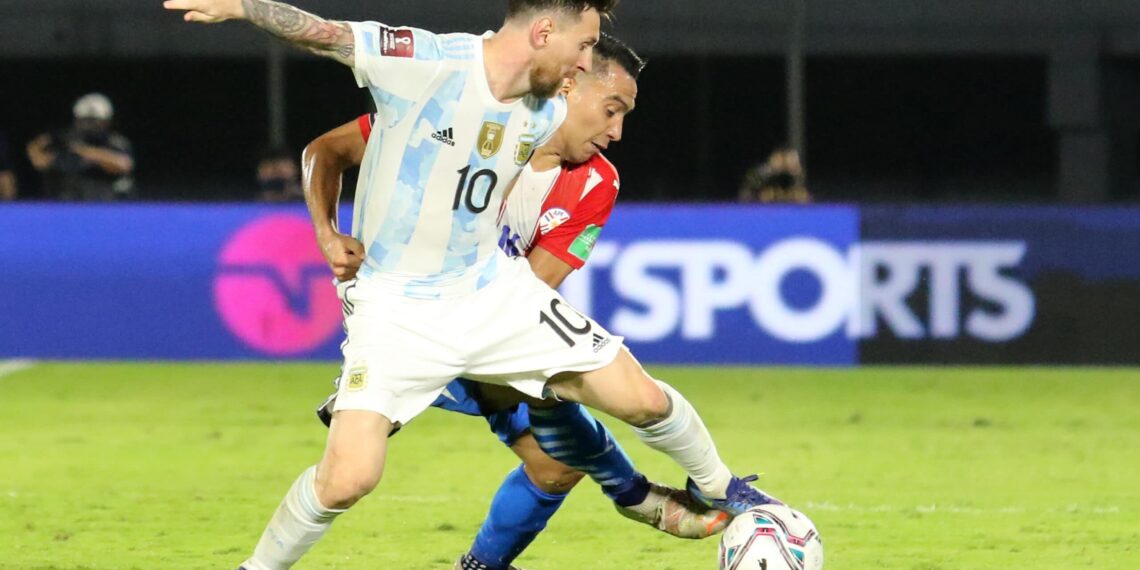 ASUNCION, PARAGUAY - OCTOBER 07: Lionel Messi of Argentina and Angel Cardozo Lucena of Paraguay fight for the ball during a match between Paraguay and Argentina as part of South American Qualifiers for Qatar 2022 at Estadio Defensores del Chaco on October 07, 2021 in Asuncion, Paraguay. (Photo by Christian Alvarenga/Getty Images)