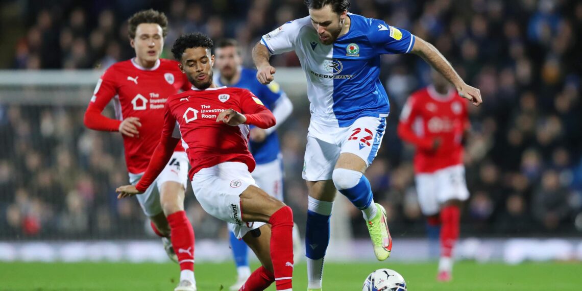 BLACKBURN, ENGLAND - DECEMBER 29: Ben Brereton of Blackburn Rovers is tackled by Romal Palmer of Barnsley during the Sky Bet Championship match between Blackburn Rovers and Barnsley at Ewood Park on December 29, 2021 in Blackburn, England. (Photo by Charlotte Tattersall/Getty Images)