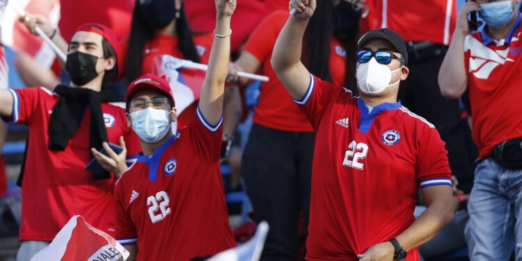 SANTIAGO, CHILE - NOVEMBER 16: Fans of Chile wearing Ben Brereton's jersey cheer for their team before a match between Chile and Ecuador as part of FIFA World Cup Qatar 2022 Qualifiers at San Carlos de Apoquindo Stadium on November 16, 2021 in Santiago, Chile. (Photo by Marcelo Hernandez/Getty Images)