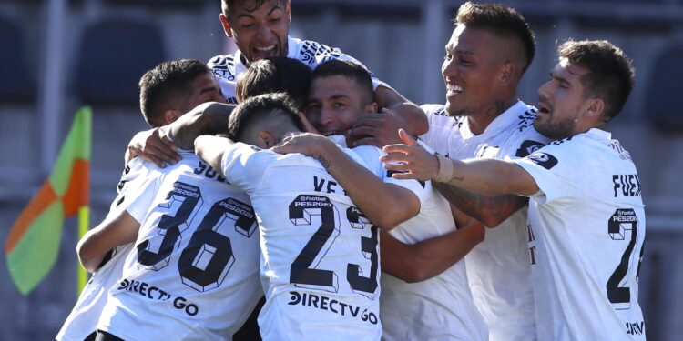 Picture released by Photosport showing Colo Colo's Argentine Pablo Solari (36) celebrating with teammates after scoring against Universidad de Concepcion during their Chilean National Championship relegation play-off at the Fiscal de Talca stadium in Talca, Chile, on February 17, 2021. - Colo Colo defeated Concepcion 1-0 to avoid relegation. (Photo by Andres PINA / PHOTOSPORT / AFP) / Chile OUT / RESTRICTED TO EDITORIAL USE (Photo by ANDRES PINA/PHOTOSPORT/AFP via Getty Images)