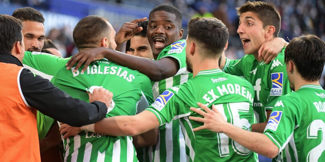 Real Betis' players celebrate after scoring a goal during the Spanish league football match between Levante UD and Real Betis at the Ciutat de Valencia stadium in Valencia on February 13, 2022. (Photo by JOSE JORDAN / AFP) (Photo by JOSE JORDAN/AFP via Getty Images)