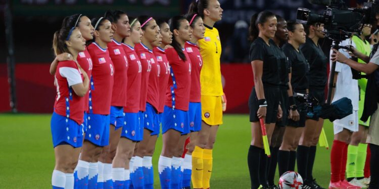The Chil team line up to sing their national anthem before the Tokyo 2020 Olympic Games women's group E first round football match between Chile and Japan at the Miyagi Stadium in Miyagi on July 27, 2021. (Photo by Kohei CHIBAHARA / AFP) (Photo by KOHEI CHIBAHARA/AFP via Getty Images)