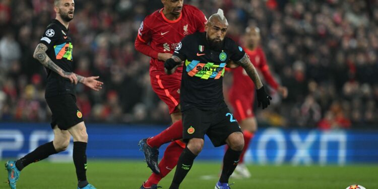 Liverpool's German-born Cameroonian defender Joel Matip (C) vies with Inter Milan's Chilean midfielder Arturo Vidal (R) during the UEFA Champions League round of 16 second leg football match between Liverpool and Inter Milan at Anfield in Liverpool, north west England on March 8, 2022. (Photo by Paul ELLIS / AFP) (Photo by PAUL ELLIS/AFP via Getty Images)