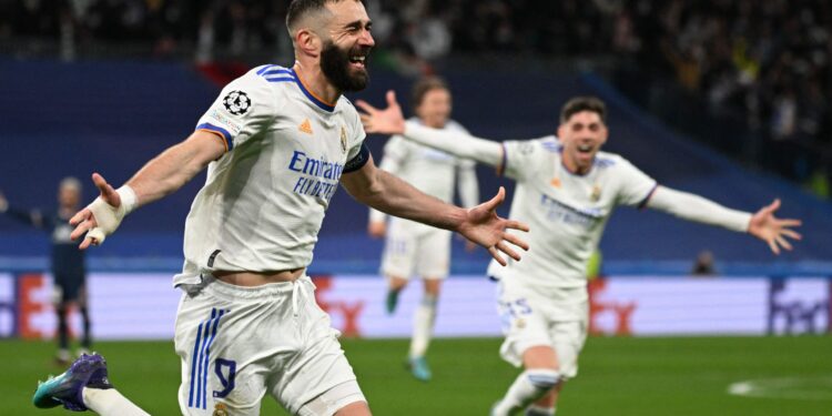 Real Madrid's French forward Karim Benzema celebrates after scoring a goal during the UEFA Champions League round of 16 second league football match between Real Madrid CF and Paris Saint-Germain at the Santiago Bernabeu stadium in Madrid on March 9, 2022. (Photo by GABRIEL BOUYS / AFP) (Photo by GABRIEL BOUYS/AFP via Getty Images)