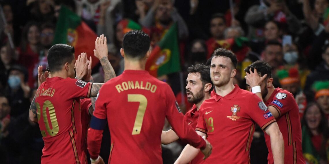 Portugal's midfielder Bruno Fernandes (C) celebrates with teammates after scoring a goal during the World Cup 2022 qualifying final first leg football match between Portugal and North Macedonia at the Dragao stadium in Porto on March 29, 2022. (Photo by MIGUEL RIOPA / AFP) (Photo by MIGUEL RIOPA/AFP via Getty Images)