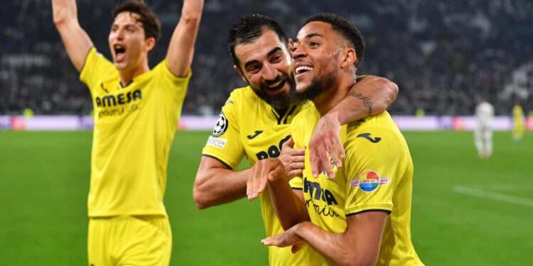 TURIN, ITALY - MARCH 16: Arnaut Danjuma of Villarreal CF celebrates their sides third goal with team mate Raul Albiol during the UEFA Champions League Round Of Sixteen Leg Two match between Juventus and Villarreal CF at Juventus Stadium on March 16, 2022 in Turin, Italy. (Photo by Valerio Pennicino/Getty Images)
