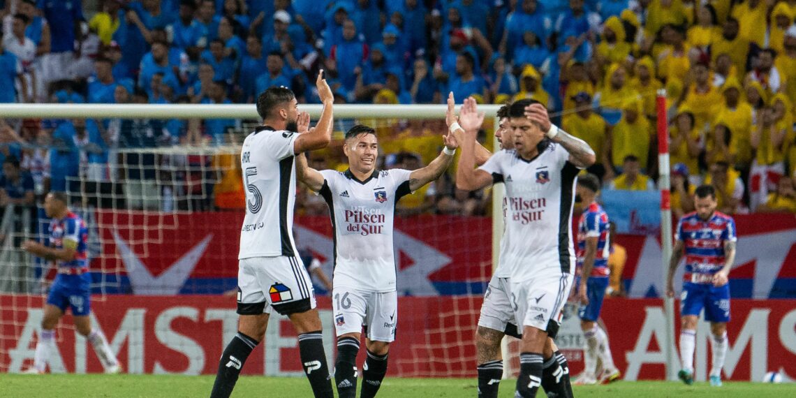 (L t R) Chile's Colo Colo Argentine Emiliano Amor (L), Oscar Opazo and Esteban Pavez  celebrate a goal against Brazil's Fortaleza during their Copa Libertadores group stage first leg football match between  at the Arena Castelao stadium, in Fortaleza, Brazil, on April 7, 2022. (Photo by Thiago Gadelha / AFP) (Photo by THIAGO GADELHA/AFP via Getty Images)