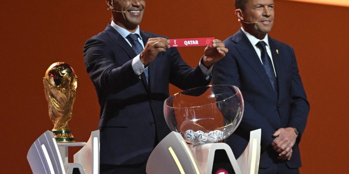 Former Brazilian footballer and World Cup winner Cafu holds the card showing the name of Qatar during the draw for the 2022 World Cup in Qatar at the Doha Exhibition and Convention Center on April 1, 2022. (Photo by François-Xavier MARIT / AFP) (Photo by FRANCOIS-XAVIER MARIT/AFP via Getty Images)