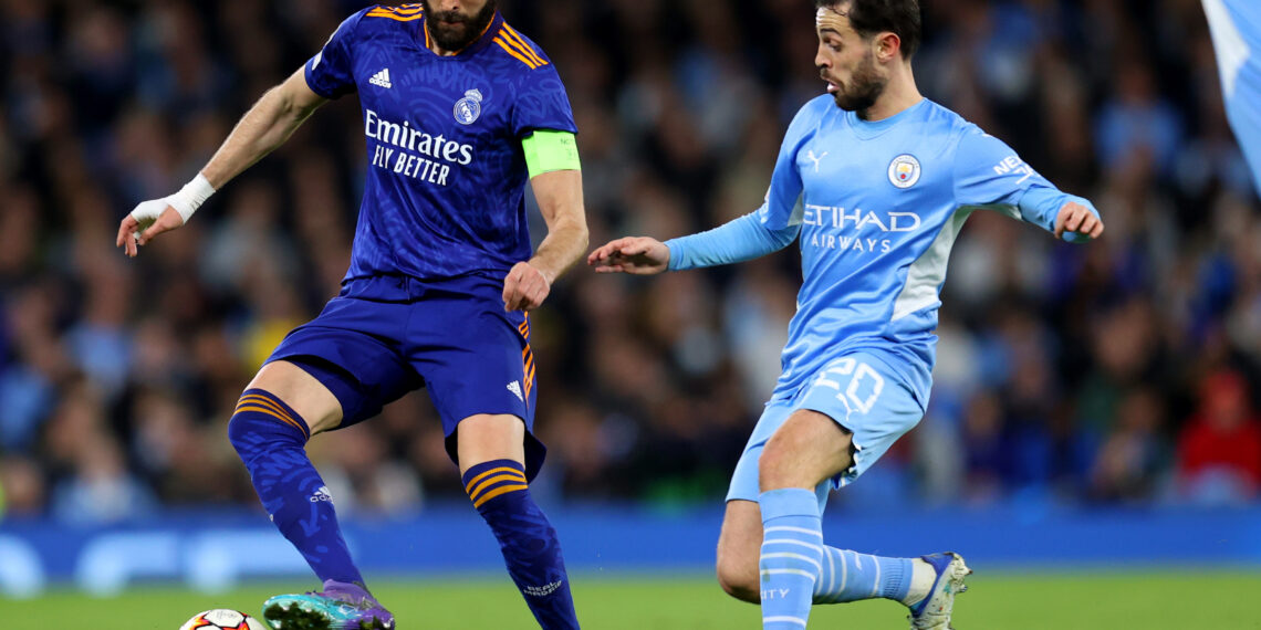 MANCHESTER, ENGLAND - APRIL 26: Karim Benzema of Real Madrid competes for possession with Bernardo Silva of Manchester City  during the UEFA Champions League Semi Final Leg One match between Manchester City and Real Madrid at City of Manchester Stadium on April 26, 2022 in Manchester, England. (Photo by Catherine Ivill/Getty Images)
